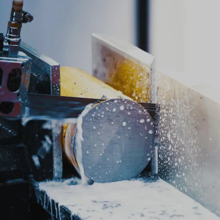 Steel billet being cut on an industrial bandsaw